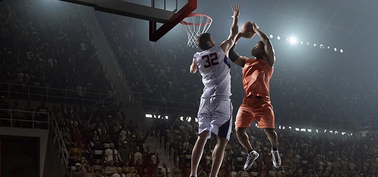 Pro basketball players on basketball court.